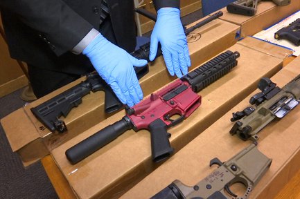 In this file photo taken Wednesday, Nov. 27, 2019, Sgt. Matthew Elseth with "ghost guns" on display at the headquarters of the San Francisco Police Department in San Francisco.
