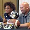 Shadow Ridge Coach Travis Foster, right, smiles during the Las Vegas Sun High School Football Media Day at the Red Rock Resort in Summerlin Tuesday, Aug. 3, 2021. Player Devon Woods listens at right. STEVE MARCUS