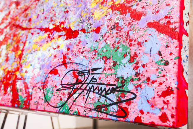 KISS singer and musician, Gene Simmons' signature is seen on one of his paintings currently on display at Animazing Gallery inside the Grand Canal Shoppes at the Venetian, Thursday, Aug. 5, 2021. The pieces in Gene Simmons ArtWorks will be publicly debuted from Oct. 14 to 16, with a private opening-day reception and two days of public presentations. YASMINA CHAVEZ