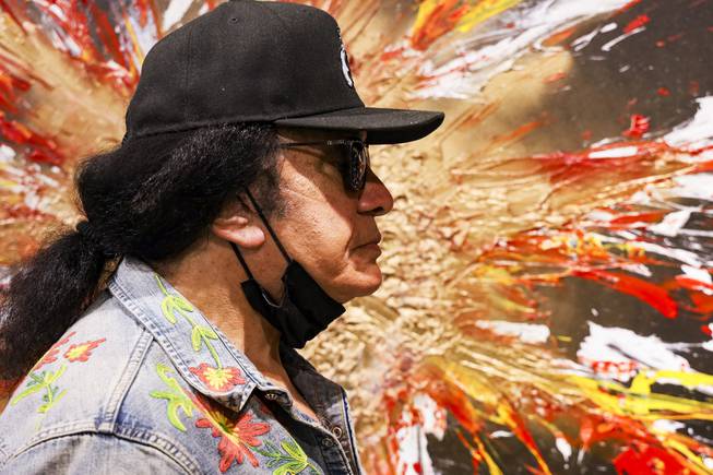 KISS singer and musician, Gene Simmons stands next to one of his paintings at Animazing Gallery inside the Grand Canal Shoppes at the Venetian, Thursday, Aug. 5, 2021. The pieces in Gene Simmons ArtWorks will be publicly debuted from Oct. 14 to 16, with a private opening-day reception and two days of public presentations. YASMINA CHAVEZ