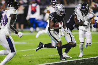 Las Vegas Raiders running back Josh Jacobs (28) runs in a touchdown during the second half of an NFL football game against the Baltimore Ravens at Allegiant Stadium Monday, Sept. 13, 2021.
