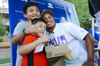 Las Vegas Raiders defensive back Johnathan Abram poses for a photo with young fans Byron, 10, and Aylan, 6, during a Big Brothers Big Sisters of Southern Nevada shoe giveaway at Springs Preserve Tuesday, Sept. 14, 2021.