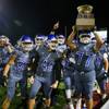 Green Valley players celebrate with the Henderson Bowl trophy after defeating Basic, 46-21, at Green Valley High School in Henderson Friday, Sept. 24, 2021.