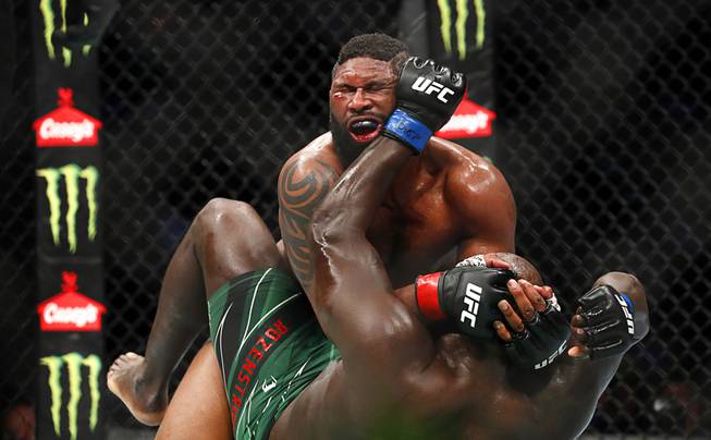 Curtis Blaydes, top, grapples with Jairzinho Rozenstruik in a heavyweight bout  during UFC 266 at T-Mobile Arena Saturday, Sept. 25, 2021. Blaydes won the bout by unanimous decisio