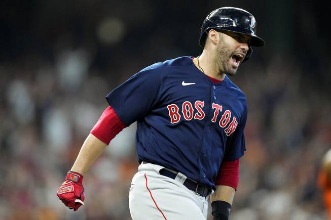 Boston Red Sox's J.D. Martinez celebrates his grand slam against the Houston Astros during the first inning in Game 2 of baseball's American League Championship Series Saturday, Oct. 16, 2021, in Houston. 

