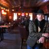 Owner Stephen Staats, also known as Old Man Liver, poses by the bar at the Pioneer Saloon in Goodspings, Nev. Wednesday, Oct. 13, 2021.