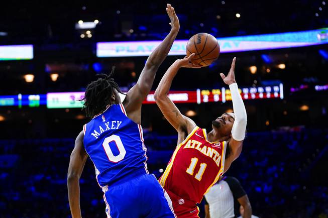 Atlanta Hawks' Trae Young, right, tries to get a shot past Philadelphia 76ers' Tyrese Maxey during the first half of an NBA basketball game, Saturday, Oct. 30, 2021, in Philadelphia. 
