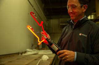 Jeffrey S. Young, Senior Vice President and Chief Marketing Officer of YESCO Custom Electric Signs, demonstrates how neon lighting works during a tour at the companys warehouse in Las Vegas, Friday Oct 29, 2021.
