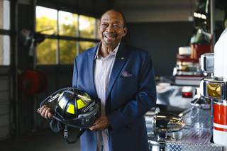 Joe Smith, Hendersons first African American firefighter, poses for a photo with an honorary helmet he received at the Henderson Fire Dept. Station 82 Monday, Nov. 15, 2021.