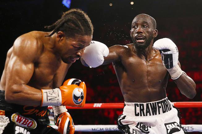 Terence Crawford hits Shawn Porter during a welterweight title boxing match Saturday, Nov. 20, 2021, in Las Vegas.