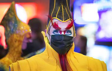 A KA cast member joins a procession to the theater following a pop-up performance in the hotel lobby celebrating the return of KA by Cirque Du Soleil at MGM Grand Wednesday, Nov. 24, 2021.