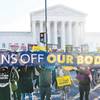 People demonstrate Wednesday, Dec. 1, 2021, in front of the U.S. Supreme Court building in Washington. Inside the court Wednesday, justices heard arguments in a case from Mississippi, where a 2018 law would ban abortions after 15 weeks of pregnancy, well before viability.