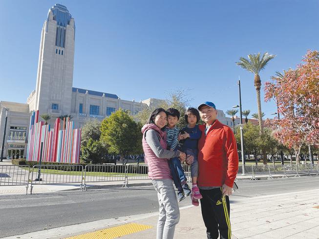 From left, Susan Lam, with children John, Grace and husband Vincent, pose Saturday for a photo outside of the Smith Center for Performing Arts. The Lams traveled from their home in Irvine, Calif., to pay respects to the late Sen. Harry Reid, whose memorial service was at the Smith Center.