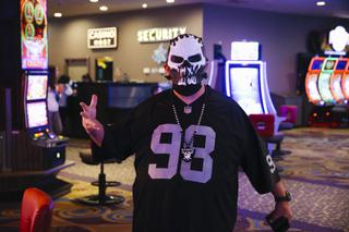 A Raiders fan poses for a photo at the Luxor before a game against the Los Angeles Chargers Sunday, Jan. 9, 2022.