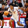 Bishop Gorman's Darrion Williams (5) drives between Liberty's Angelo Kambala (2) and Joshua Jefferson (5) during a game at Liberty High School Thursday, Jan. 27, 2022.