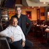 Owner Freddie Glusman and his son Evan pose at Pieros Italian Cuisine, across from the Las Vegas Convention Center, Wednesday, Feb. 9, 2022. The restaurant opened near downtown in 1982 and moved to its current location in 1987.