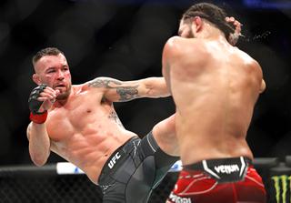 Colby Covington kicks Jorge Masvidal in a welterweight bout during UFC 272 at T-Mobile Arena Saturday, March 5, 2022.