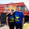 Ellen Doren and Bulat Nasybulin pose for a photo in front of thier Eastern European food truck Wed. March 16, 2022. 10% of their sales will be donated to World Central Kitchen to help feed Ukrainian refugees.