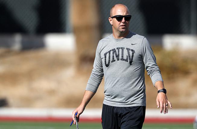 Nick Holtz, offensive coordinator and quarterbacks coach, watches players during the first day of UNLV spring football practice at Rebel Park on UNLV campus Tuesday, March 29, 2022.