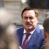 Mike Lindell, chief executive officer of MyPillow, talks to reporters before attending a rally outside the State Capitol, April 5, 2022, in downtown Denver.