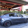 A Tesla Model Y, one of the rental vehicles available from EVolve Tesla Rentals, is shown in a porte cochere at Resorts World, Tuesday, May 3, 2022.