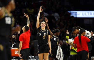 Las Vegas Aces forward Dearica Hamby (5) celebrates from the bench after a basket by guard Chelsea Gray (12) during a WNBA basketball game against the Minnesota Lynx at Michelob Ultra Arena in Las Vegas Thursday, May 19, 2022.
