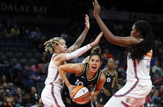 Las Vegas Aces guard Kelsey Plum (10) is guarded by Connecticut Sun guard Courtney Williams (10) and forward Jonquel Jones (35) during a WNBA basketball game at the Michelob Ultra Arena Thursday, June 2, 2022.