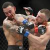 Alexander Volkanovski lands an elbow to Max Holloway in a mixed martial arts featherweight championship bout at UFC 245, Saturday, Dec. 14, 2019, in Las Vegas.