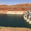 FILE - This Aug. 21, 2019 file photo shows Glen Canyon Dam in Page, Ariz. The elevation of Lake Powell fell below 3,525 feet (1,075 meters), a record low that surpasses a critical threshold at which officials have long warned signals their ability to generate hydropower is in jeopardy. (AP Photo/Susan Montoya Bryan,File)