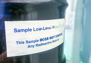 A label is shown on a simulated, low-level nuclear waste drum in a new exhibit at the National Atomic Testing Museum Friday, August 5, 2022. The new exhibit, Beyond the Manhattan Project: Cleaning up the Legacy of Americas Nuclear Defense and Research Missions, details efforts taken to clean up sites contaminated by radiation.