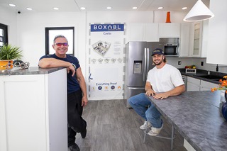 Co-founders Paolo Tiramani, left, and his his son Galiano pose in a model Boxabl casita outside the Boxabl factory in North Las Vegas Wednesday, Aug. 10, 2022.