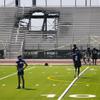 Students practice on the field where a section of bleacher has collapsed due to a fire at Sunrise Mountain High School Tuesday, Aug. 23, 2022.