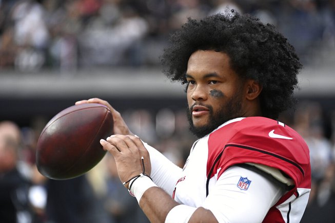 Arizona Cardinals quarterback Kyler Murray warms up on the sideline during the first half of an NFL football game against the Las Vegas Raiders Sunday, Sept. 18, 2022, in Las Vegas. 