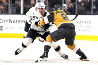 Los Angeles Kings defenseman Jordan Spence (53) and Vegas Golden Knights center Jonathan Marchessault (81) battle for the puck during the first period of an NHL preseason hockey game Monday, Sept. 26, 2022, in Las Vegas. (AP Photo/John Locher)