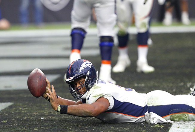 Denver Broncos quarterback Russell Wilson (3) slides into the end zone for a touchdown during an NFL football game against the Las Vegas Raiders at Allegiant Stadium Sunday, Oct. 2, 2022.