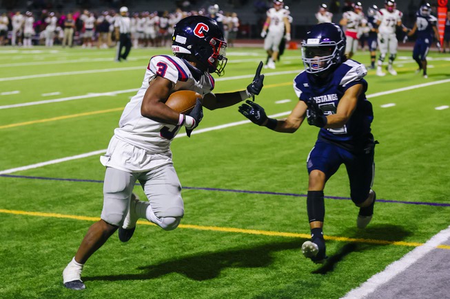 Coronado wide receiver Isaiah Bottley (3) runs the ball in for a touchdown as Shadow Ridge free safety Kela Cox (2) tries to stop him during a game at Shadow Ridge High School Friday, Oct. 7, 2022.
