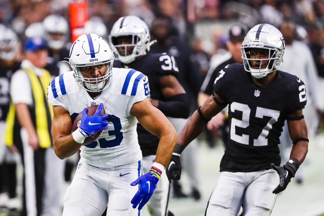 Indianapolis Colts tight end Kylen Granson (83) runs the ball as Las Vegas Raiders cornerback Sam Webb (27) chases after him during an NFL football game against the Indianapolis Colts at Allegiant Stadium Sunday, Nov. 13, 2022.