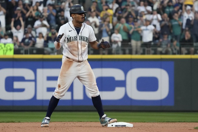 Seattle Mariners's Julio Rodriguez reacts after stealing second base during the 13th inning in Game 3 of an American League Division Series baseball game against the Houston Astros, Saturday, Oct. 15, 2022, in Seattle. 

