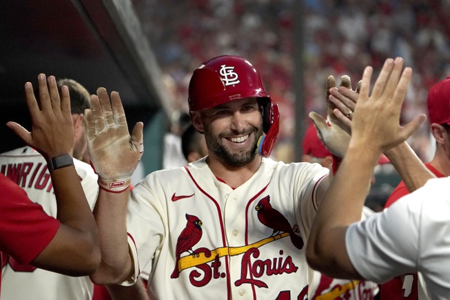 St. Louis Cardinals' Paul Goldschmidt is congratulated by teammates after scoring during the seventh inning of a baseball game against the Milwaukee Brewers Saturday, Aug. 13, 2022, in St. Louis. New AL home run king Aaron Judge and St. Louis slugger Paul Goldschmidt won Hank Aaron Awards on Wednesday, Nov. 9, 2022, that reward the most outstanding offensive performers in each league. 
