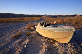 A previously submerged boat is now adjacent to a road in the Government Wash area of the Lake Mead National Recreation Area Saturday, Nov. 19, 2022.