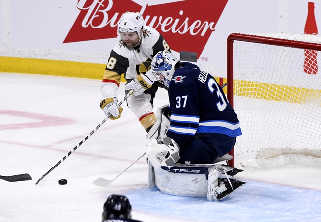 Vegas Golden Knights' Phil Kessel (8) takes a shot on Winnipeg Jets goaltender Connor Hellebuyck (37) during the first period in Winnipeg, Manitoba on Tuesday, Dec. 13, 2022. 


