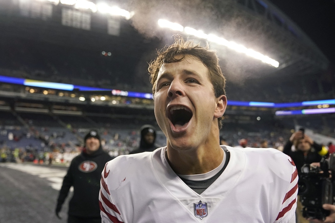 San Francisco 49ers quarterback Brock Purdy celebrates after the 49ers defeated the Seattle Seahawks in an NFL football game in Seattle, Thursday, Dec. 15, 2022. 
