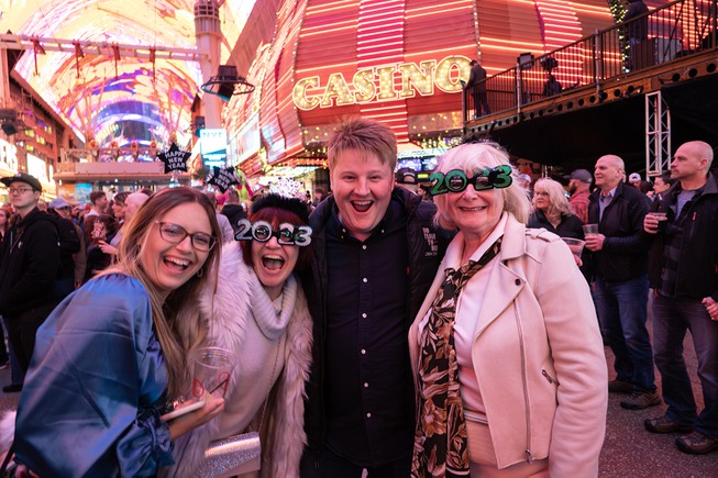 Revelers pose for a photo during the New Years Eve party on the Fremont Street Experience Saturday December 31, 2022.