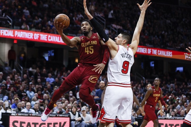 Cleveland Cavaliers guard Donovan Mitchell (45) shoots against Chicago Bulls center Nikola Vucevic (9) during the second half Monday, Jan. 2, 2023, in Cleveland.


