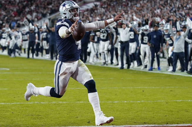 Dallas Cowboys quarterback Dak Prescott (4) runs into the end zone on a touchdown carry during the first half of an NFL wild-card football game against the Tampa Bay Buccaneers, Monday, Jan. 16, 2023, in Tampa, Fla. 


