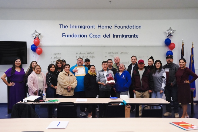 William H. Ortiz, center, celebrates Thursday, Jan. 26,2023, with students in his class at the Immigrant Home Foundation. Earlier Thursday he was sworn in as a new citizen of the United States.