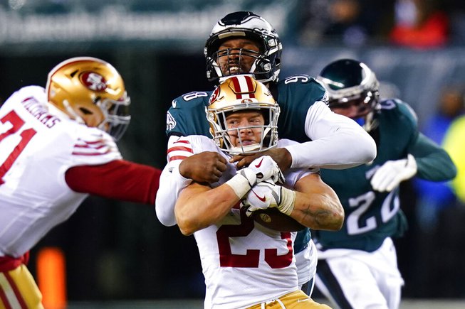 San Francisco 49ers running back Christian McCaffrey (23) is tackled by Philadelphia Eagles defensive end Robert Quinn during the second half of the NFC Championship NFL football game between the Philadelphia Eagles and the San Francisco 49ers on Sunday, Jan. 29, 2023, in Philadelphia.