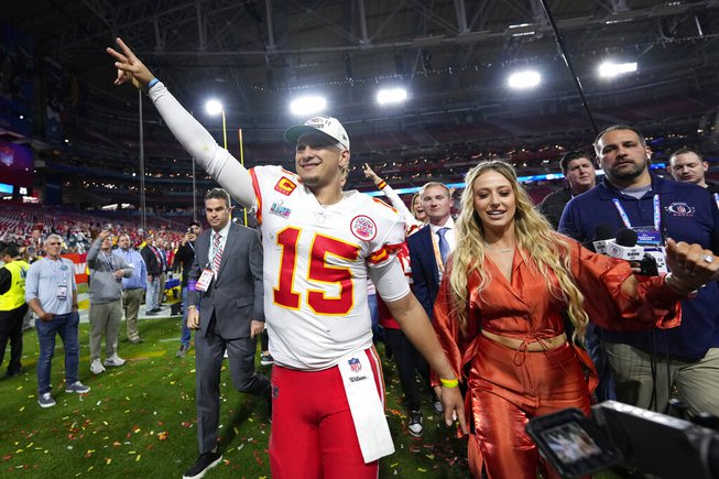Kansas City Chiefs quarterback Patrick Mahomes (15) leaves the field with his wife, Brittany, after the NFL Super Bowl 57 football game, Sunday, Feb. 12, 2023, in Glendale, Ariz. The Chiefs defeated the Philadelphia Eagles 38-35.