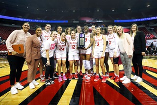 UNLV Lady Rebels and coaches gather behind the Mountain West trophy after the Lady Rebels defeated the San Jose State Spartans to earn the regular season Mountain West championship at the Thomas & Mack Center in Las Vegas Thursday, Feb. 16, 2023.
