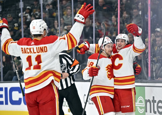 Calgary Flames center Mikael Backlund (11), left wing Andrew Mangiapane (88) and left wing Jakob Pelletier, right, celebrate after Pelletier's goal against the Vegas Golden Knights during the first period Thursday, Feb. 23, 2023, in Las Vegas.


